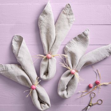 folded napkins with wooden craft beads and raffia to look like a bunny